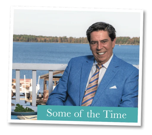 Oliver C. Brown seated on a waterfront deck in a light blue jacket, captioned “Some of the Time”
